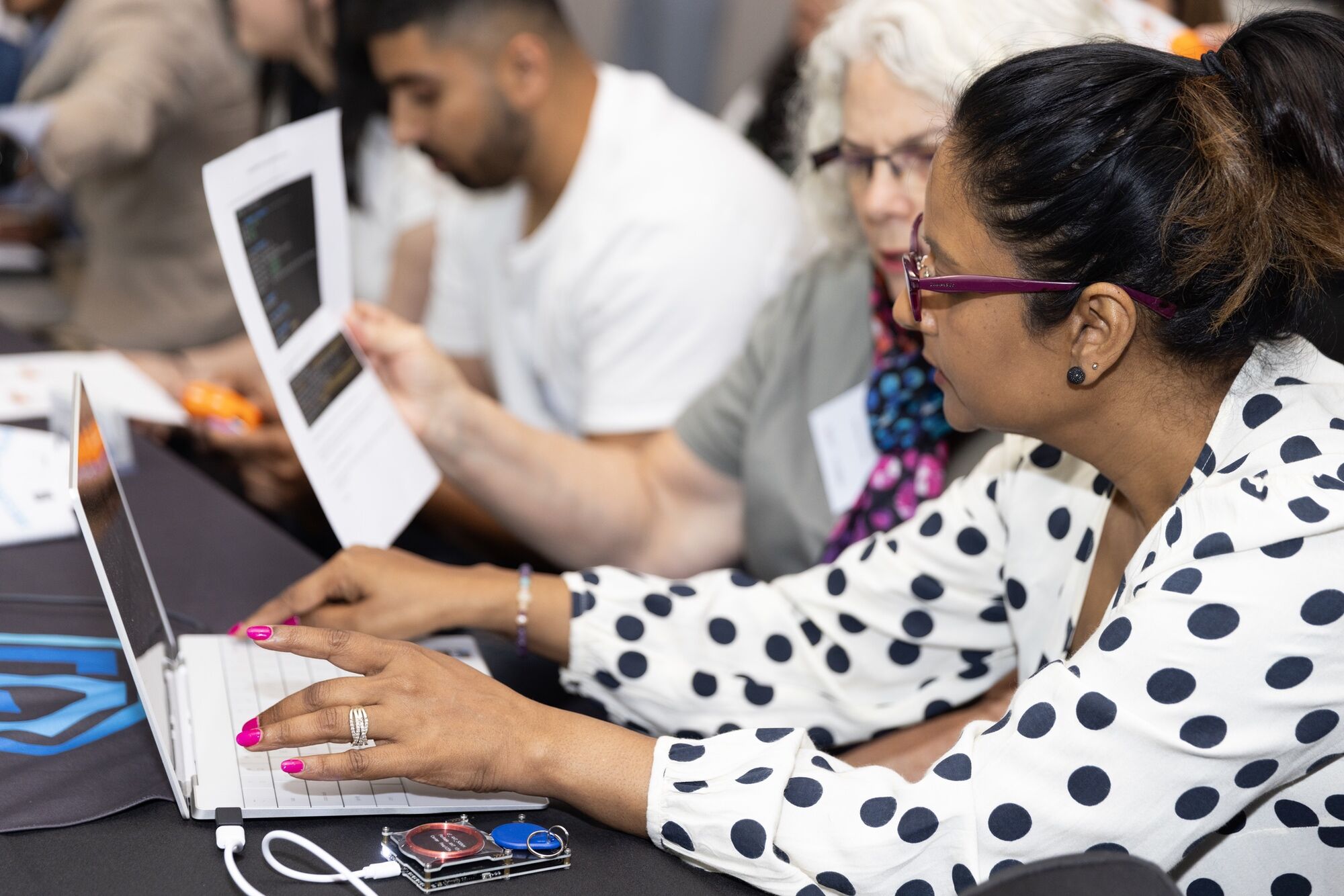 Two women working on a laptop